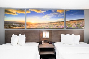 A hotel room with two beds, a nightstand, a phone, and a wall-mounted light. - Days Inn by Wyndham Sharonville (Sharonville)