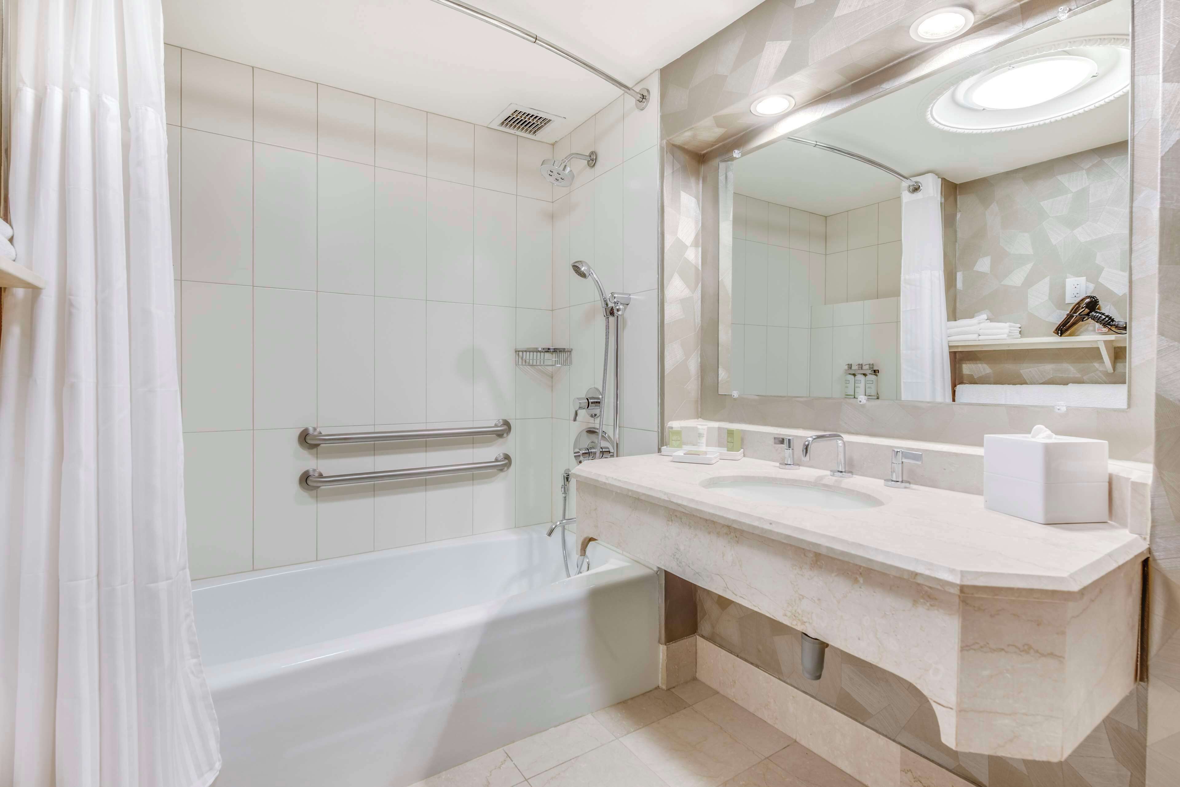 designer toiletries, hair dryer, towels