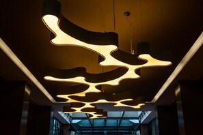 A modern interior with a unique ceiling design featuring abstract light fixtures. - Hilton Washington DC Capitol Hill (Washington)