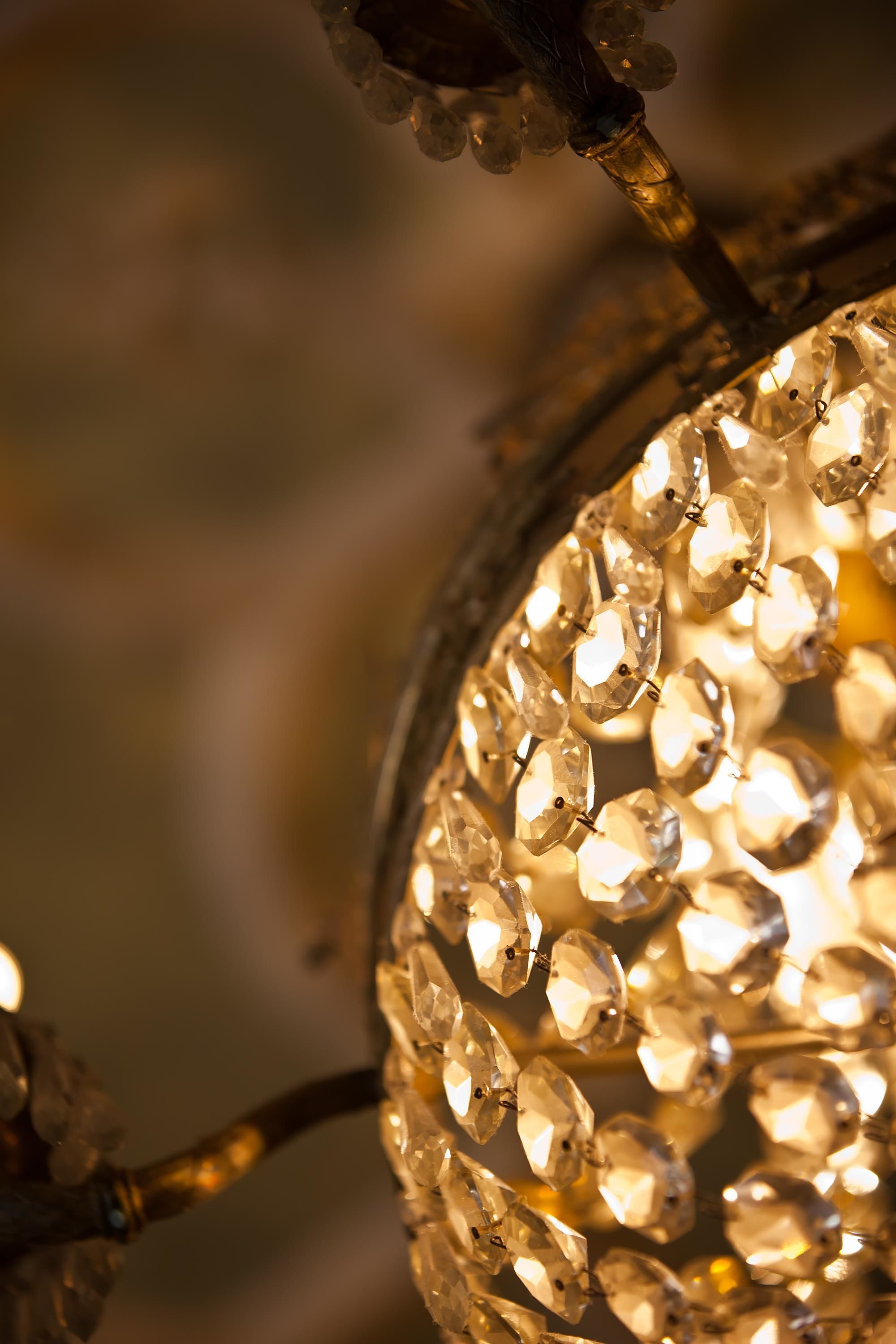 A close-up of a chandelier with multiple clear crystal-like decorations.
