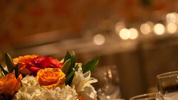 A table set with a vase of flowers and candles.