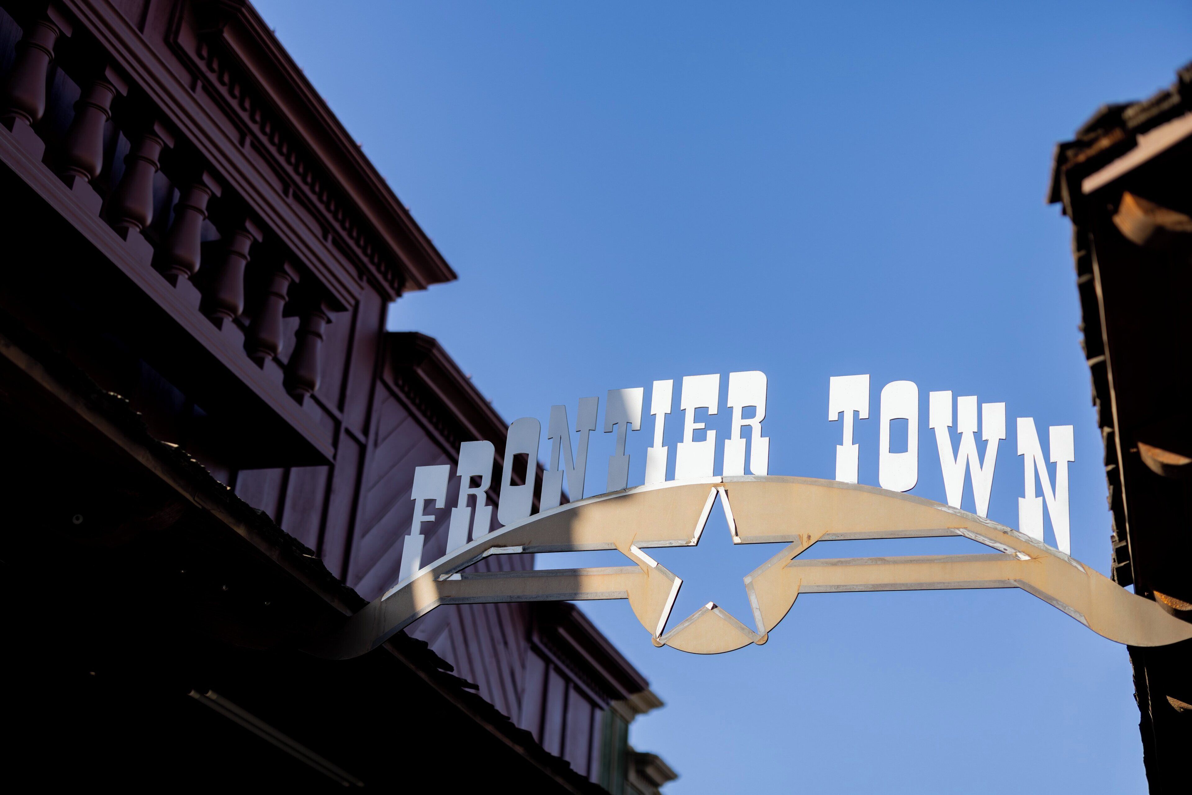 A sign with 'FRONTIER TOWN' and a star emblem.