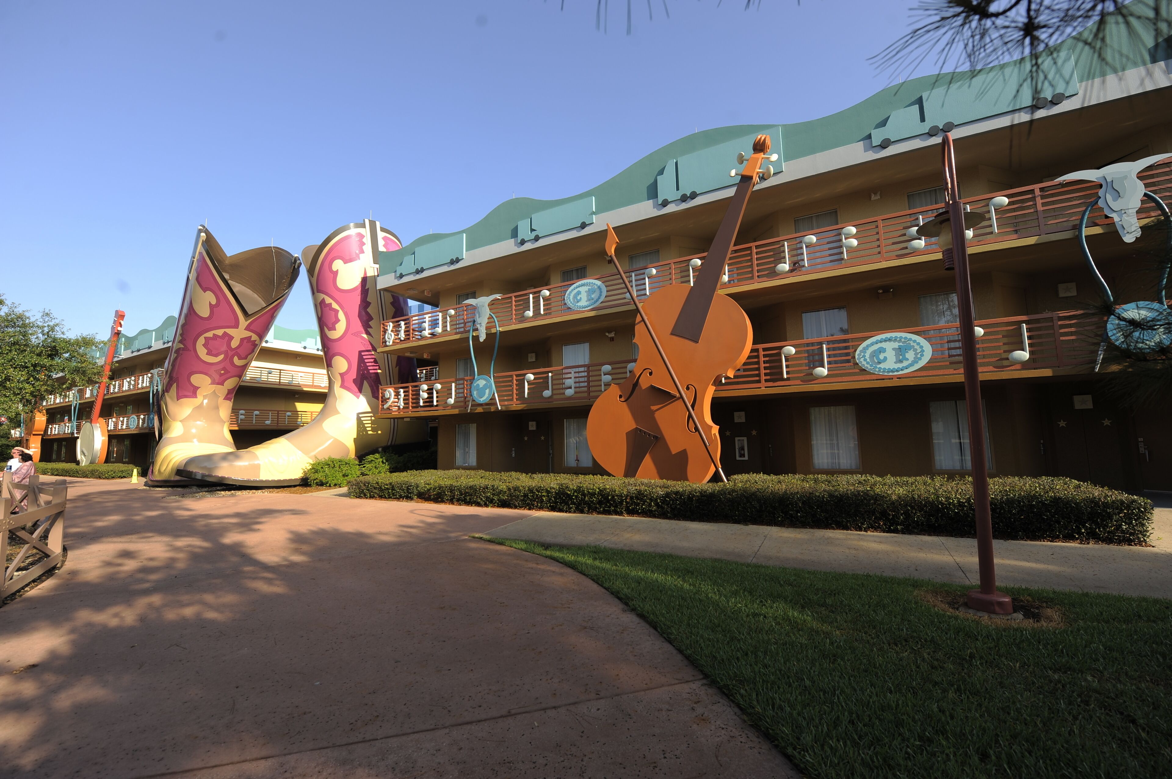 A hotel with a distinctive architectural design featuring large, colorful sculptures of a cow's legs and a cow skull.