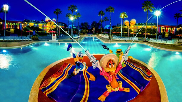 A swimming pool with a water slide, palm trees, and a building with 'CALYPSO' signage. - Disney's All-Star Music Resort (Lake Buena Vista)