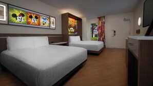 A hotel room with two beds, a desk, and a TV. There are Mickey and Donald Duck posters on the wall. - Disney's All-Star Music Resort (Lake Buena Vista)