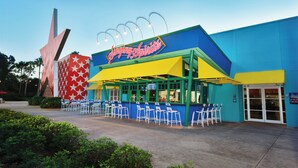 A building with a colorful exterior and a sign that reads "Singing Spirits." - Disney's All-Star Music Resort (Lake Buena Vista)