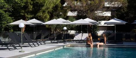 Seasonal outdoor pool, open 9:00 AM to 8:00 PM, pool umbrellas