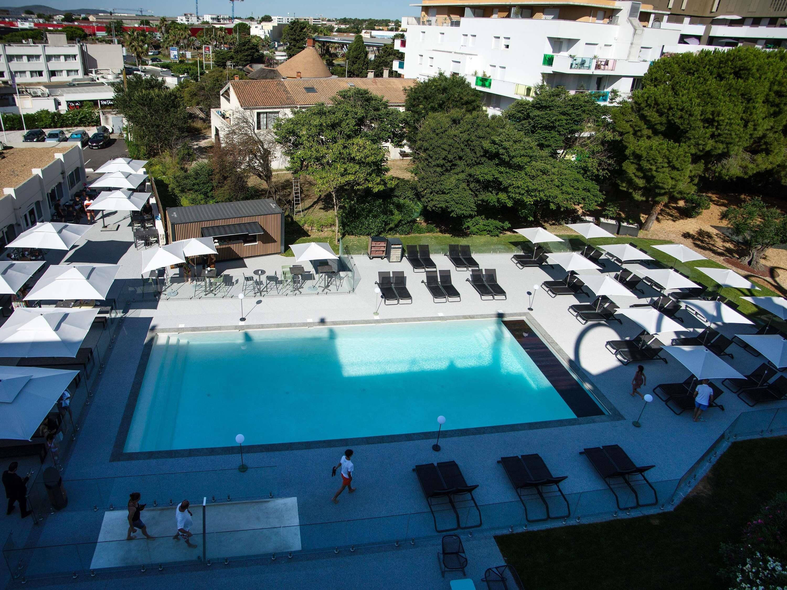 Seasonal outdoor pool, open 9:00 AM to 8:00 PM, pool umbrellas