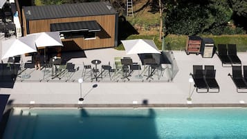 Seasonal outdoor pool, open 9:00 AM to 8:00 PM, pool umbrellas