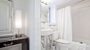 Un baño moderno con tocador, lavabo, inodoro y ducha.