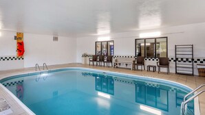 An indoor swimming pool with clear water, tiled walls, and a checkered pattern near the pool's edge. - Comfort Inn Rockford near Casino District (Rockford)