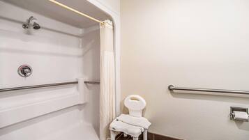 A bathroom with a shower, toilet, and grab bars.