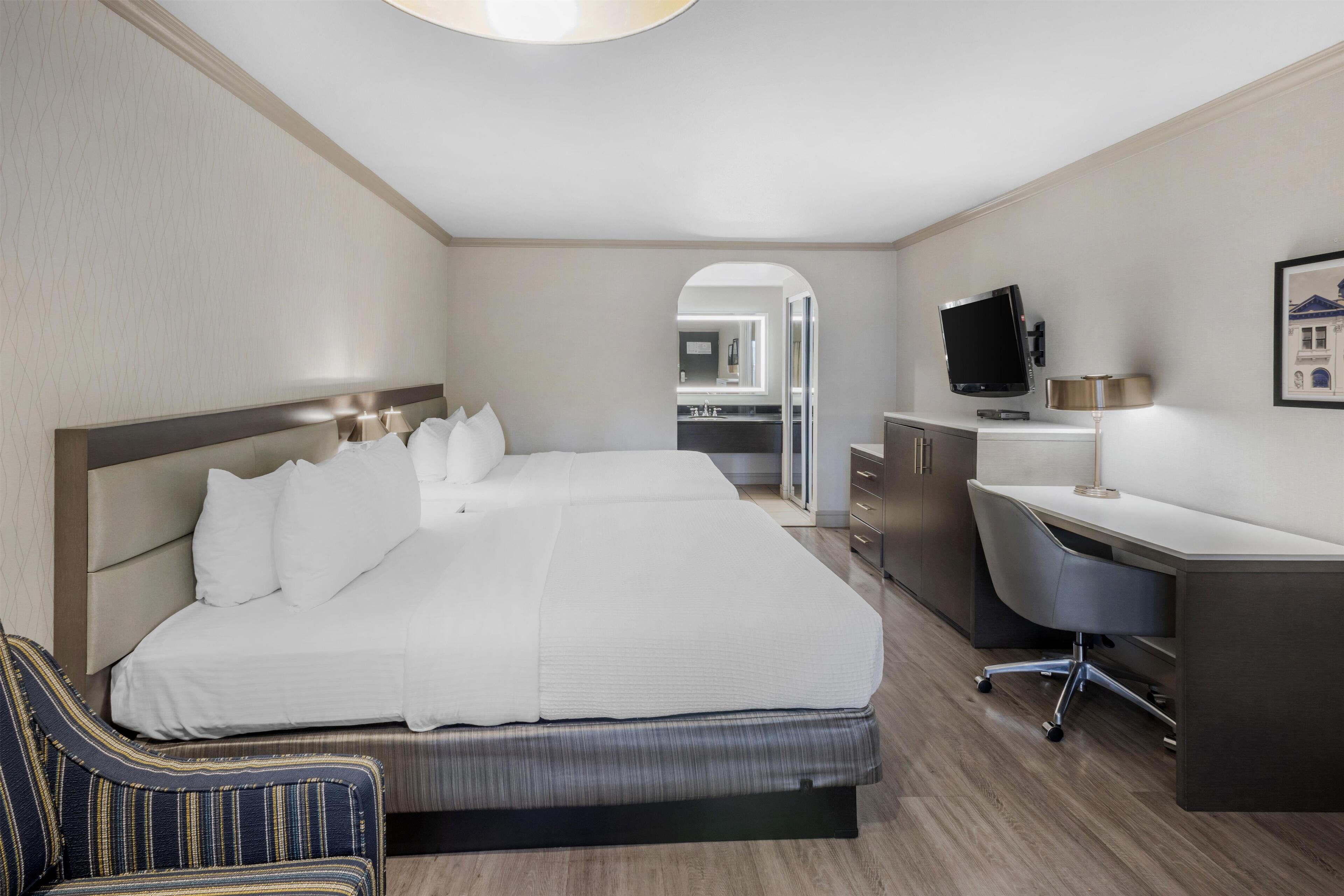 Premium bedding, desk, laptop workspace, blackout curtains