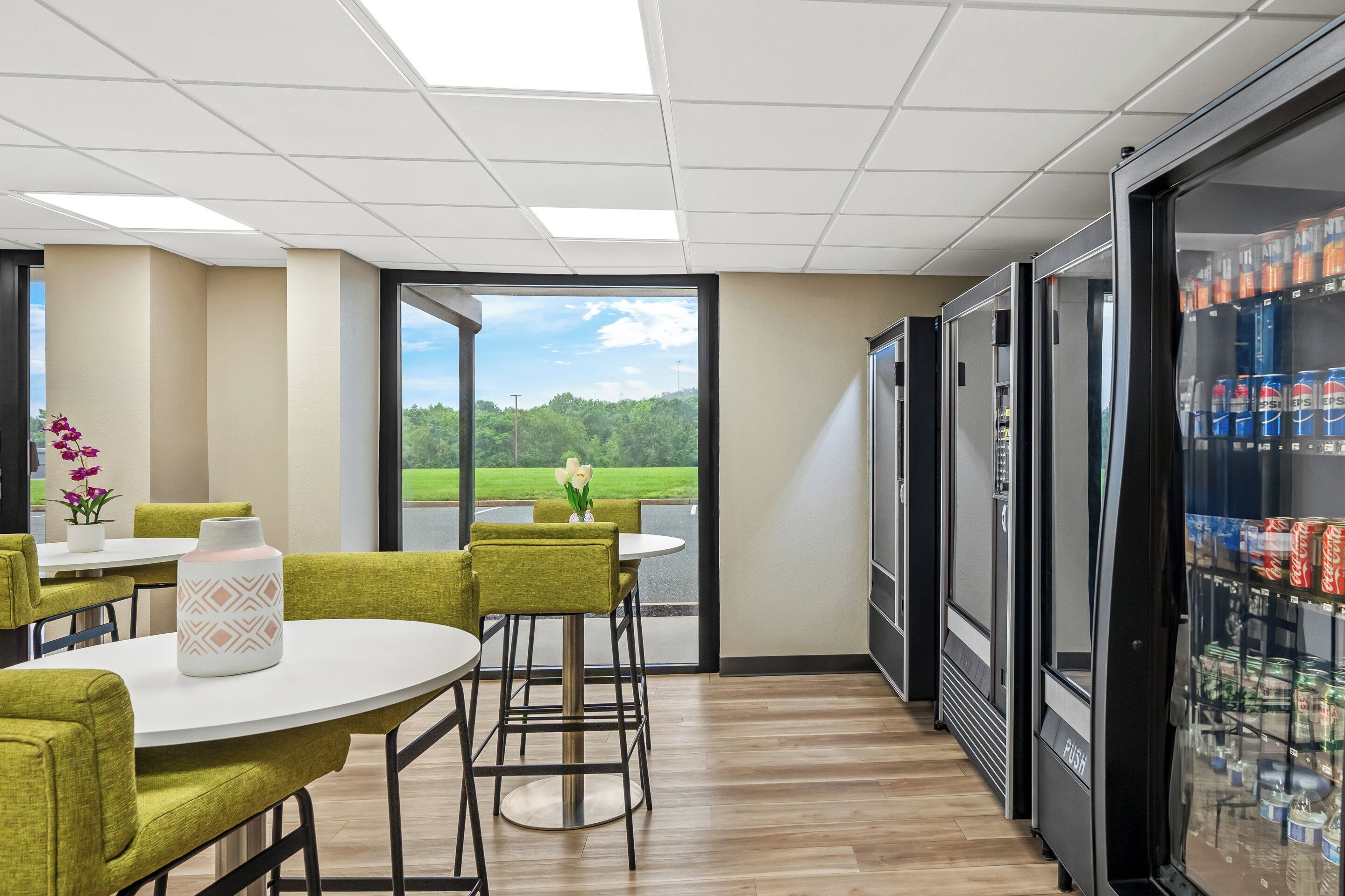 A modern interior with a dining area, large windows, and a beverage refrigerator.