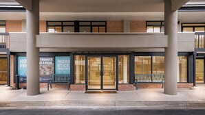 A building entrance with glass doors, a bench, and a sign that reads "STRONGER PACKS STICK TOGETHER". - Red Roof Inn Perryville (Perryville)