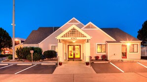 A hotel entrance with a number sign, a gated driveway, and a parking lot. - Residence Inn by Marriott Denver Tech Center (Greenwood Village)