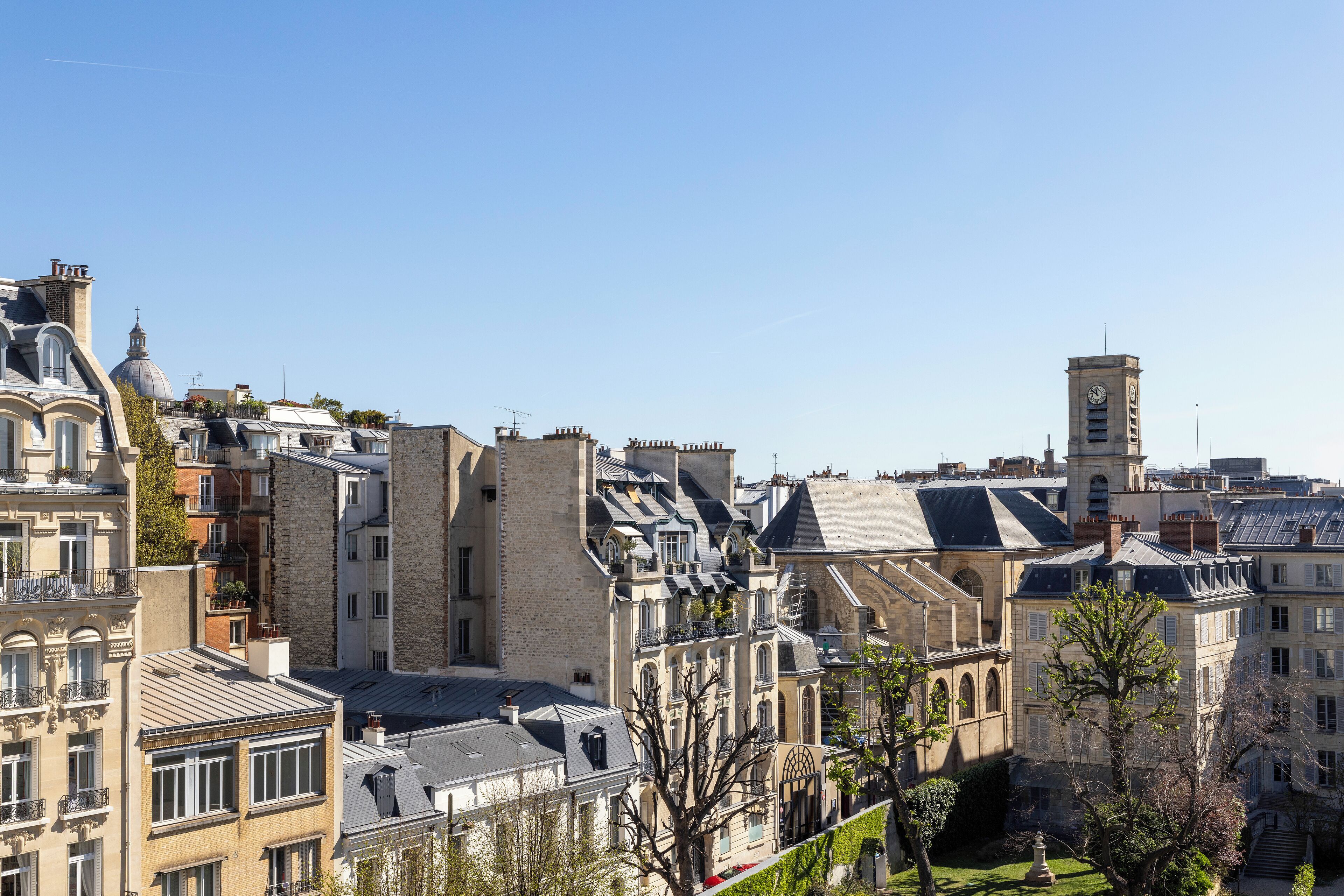 A historic urban area with traditional architecture, including a prominent tower and a variety of building styles.
