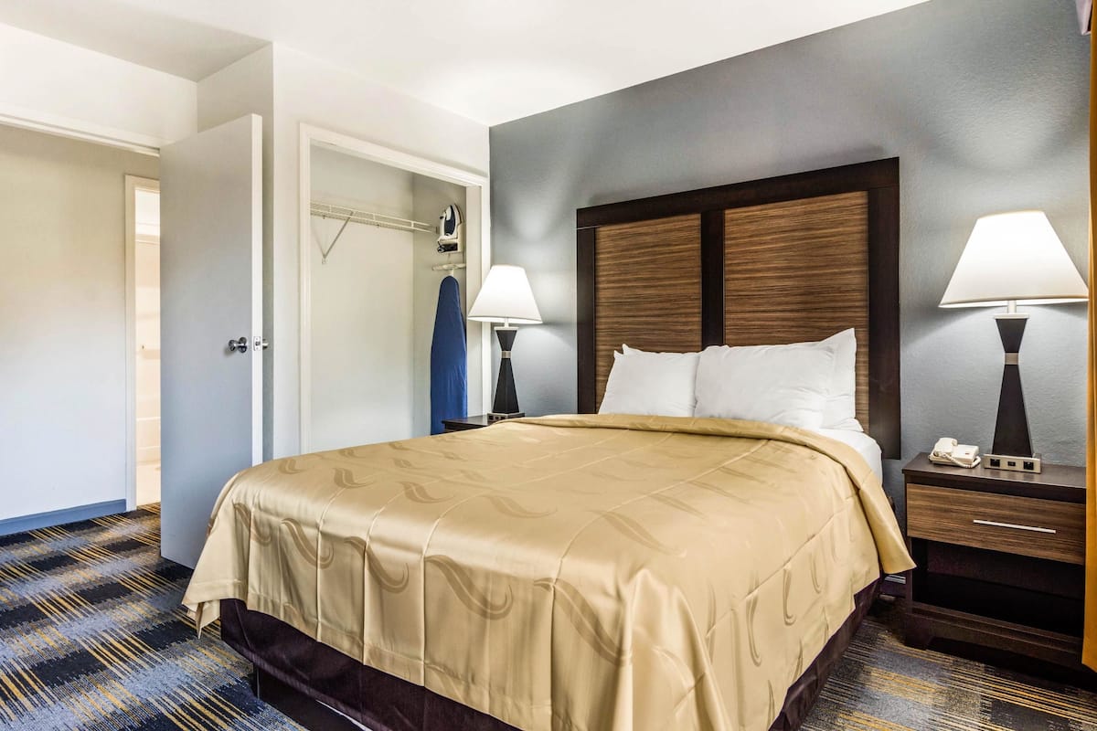 Premium bedding, desk, laptop workspace, iron/ironing board
