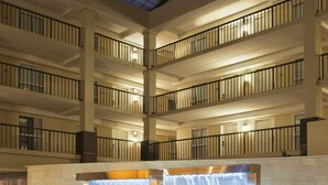 A multi-level atrium with a glass ceiling, water features, and a central reception area. - Embassy Suites by Hilton Cleveland Beachwood (Beachwood)