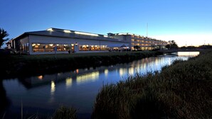 A modern building with large windows and a reflective water body in front. - Shilo Inn Suites Idaho Falls (Idaho Falls)