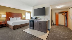 A hotel room with a bed, a small kitchenette, a flat-screen TV, and a walk-in closet. - Best Western Chicago - Downers Grove (Downers Grove)