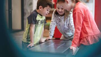 Guests can interact with a digital display in this modern indoor space.