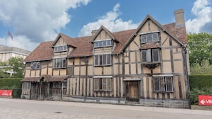 A traditional half-timbered building with multiple windows and a tiled roof.