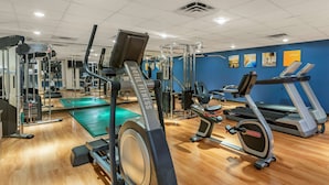 A gym with cardio machines, weight equipment, and a green exercise mat. - Comfort Suites Oakbrook Terrace - Chicago West (Villa Park)