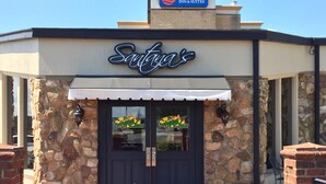 A restaurant named 'Santee's' with a stone facade, a black door, and a white awning.