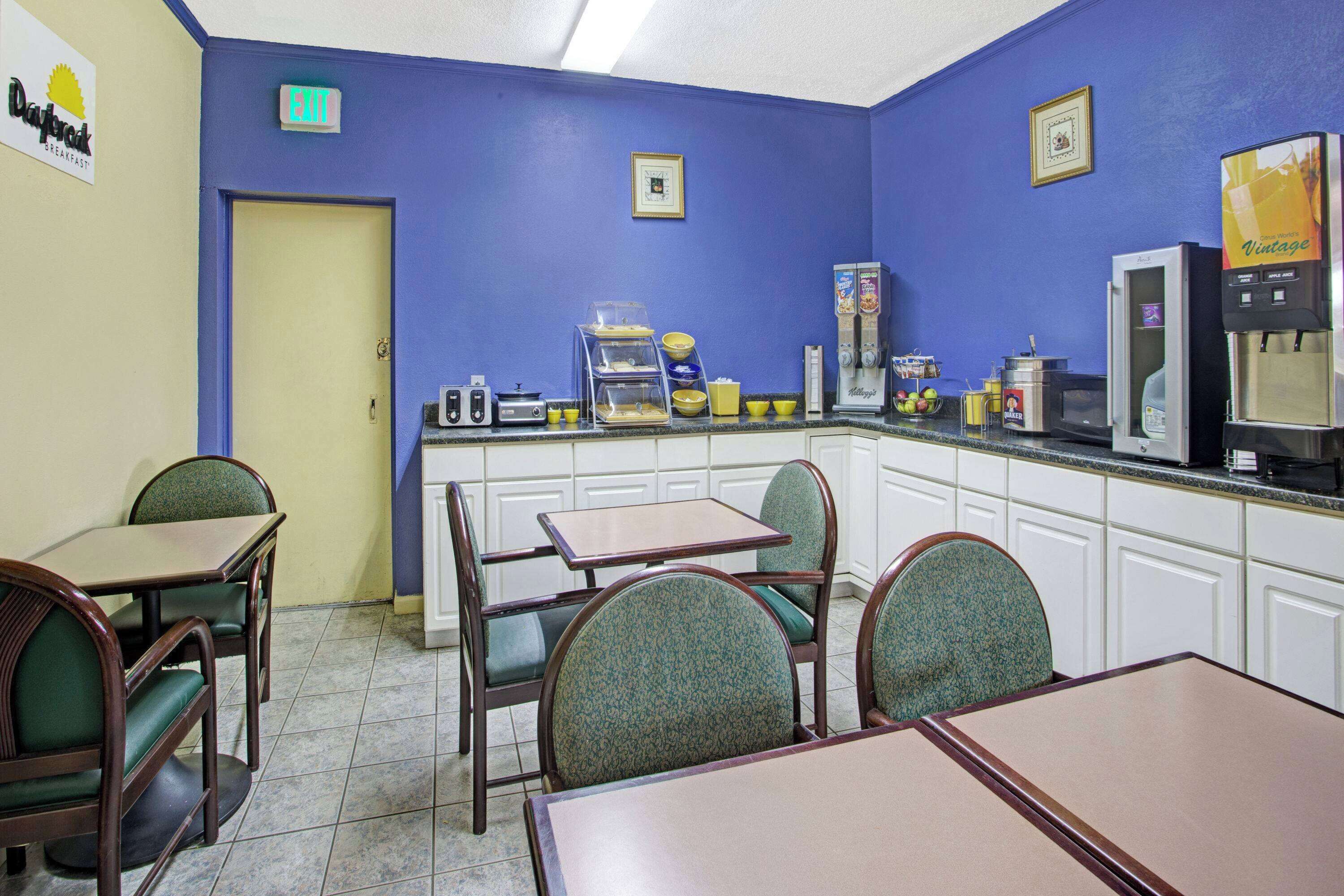 A diner with blue walls, a coffee machine, and a breakfast bar.
