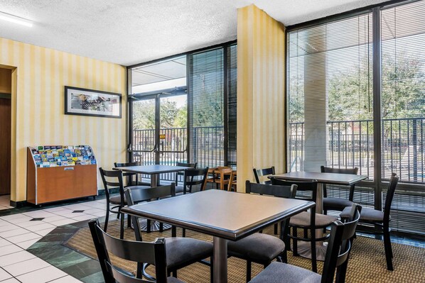 Enjoy meals in the room's dining area with tables and chairs.