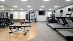 A gym with treadmills, weight machines, and dumbbells. - Fairfield by Marriott Inn & Suites Clinton (Clinton)