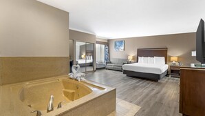 A hotel room with a large bathtub, a bed, a sofa, and a TV. - Best Western Redondo Beach Galleria Hotel - Beach City LA (Redondo Beach)