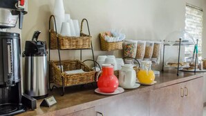 A breakfast bar with coffee machines, baskets, and dispensers. - Rodeway Inn Allentown South (Allentown)