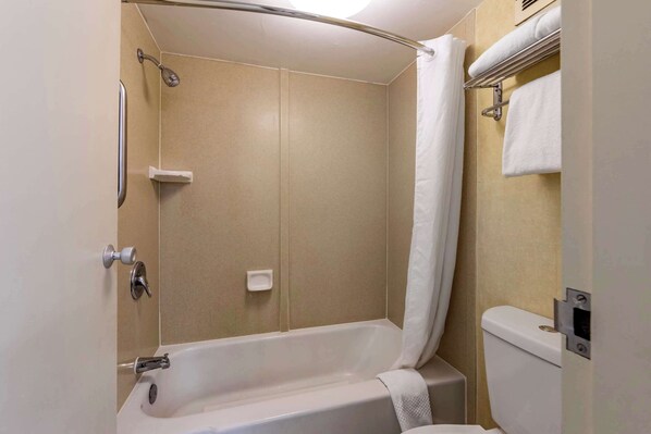 A bathroom with a bathtub, a shower, and a toilet.