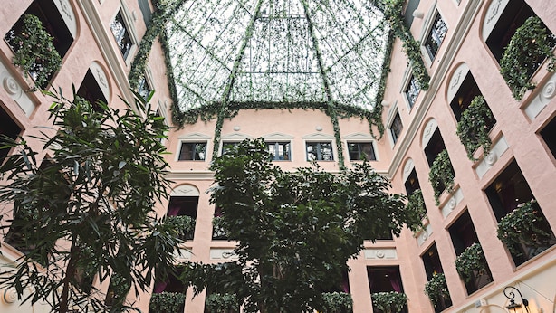 A multi-level atrium with a glass ceiling, allowing natural light to illuminate the space. - MJ's (Malmö)