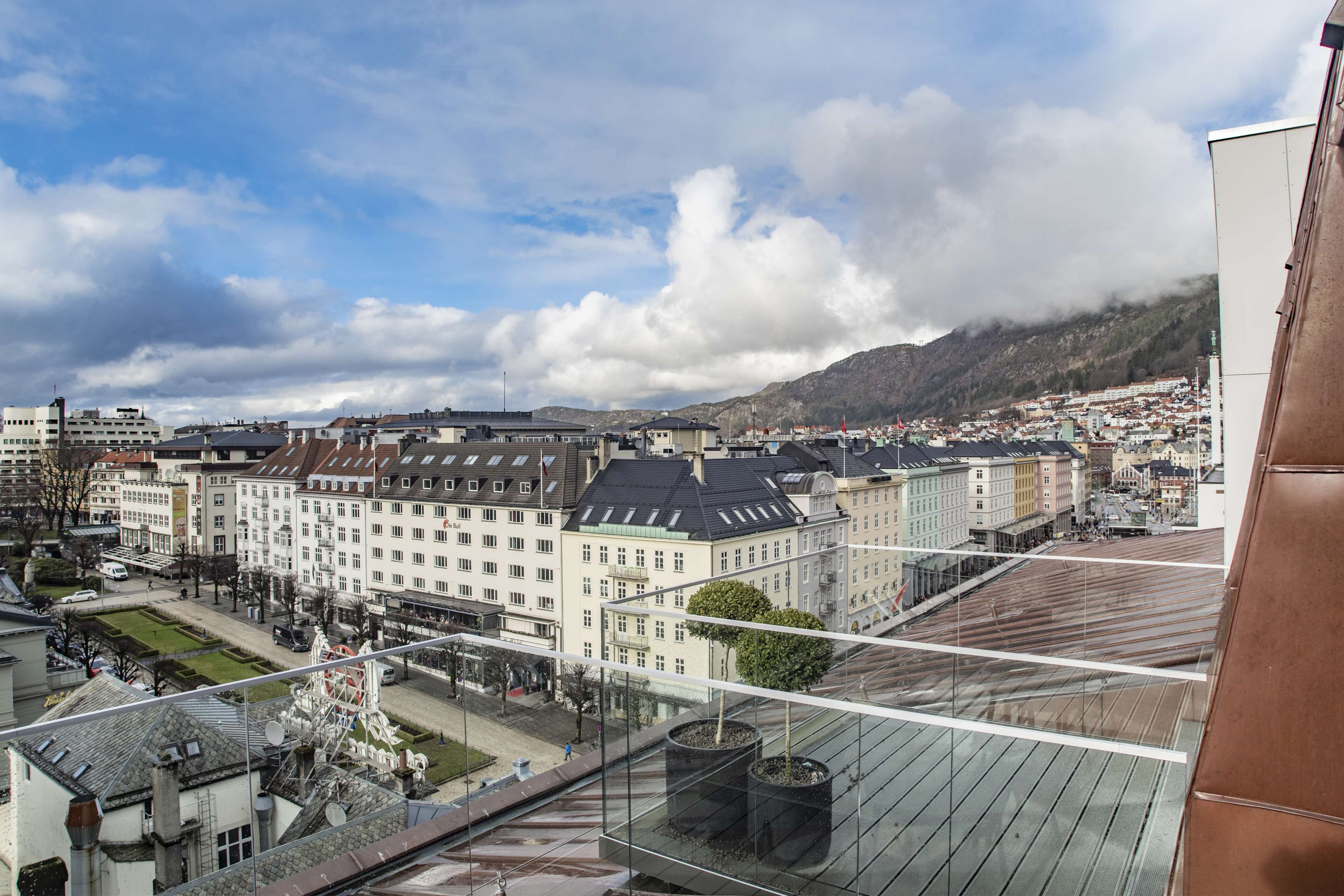 A cityscape with a view of buildings and a mountain in the background.