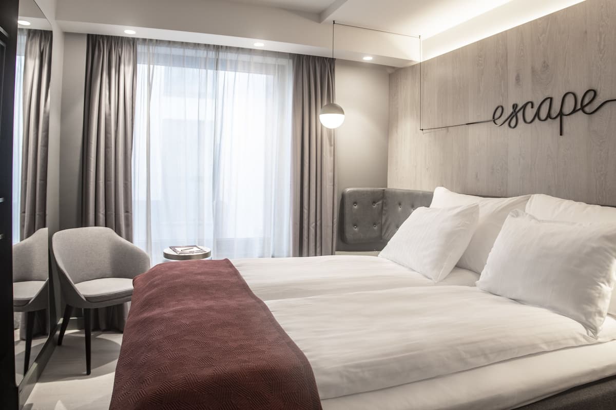 classic double room, 1 queen bed, balcony | minibar, in-room safe, desk, blackout curtains