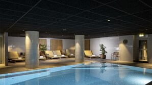 A swimming pool with lounge chairs and a clock on the wall.