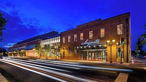 A building with a sign reading "Angeles Convention Center" and a modern glass facade.