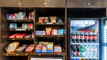 A vending machine stocked with snacks and beverages, including chips, candy, and sodas.