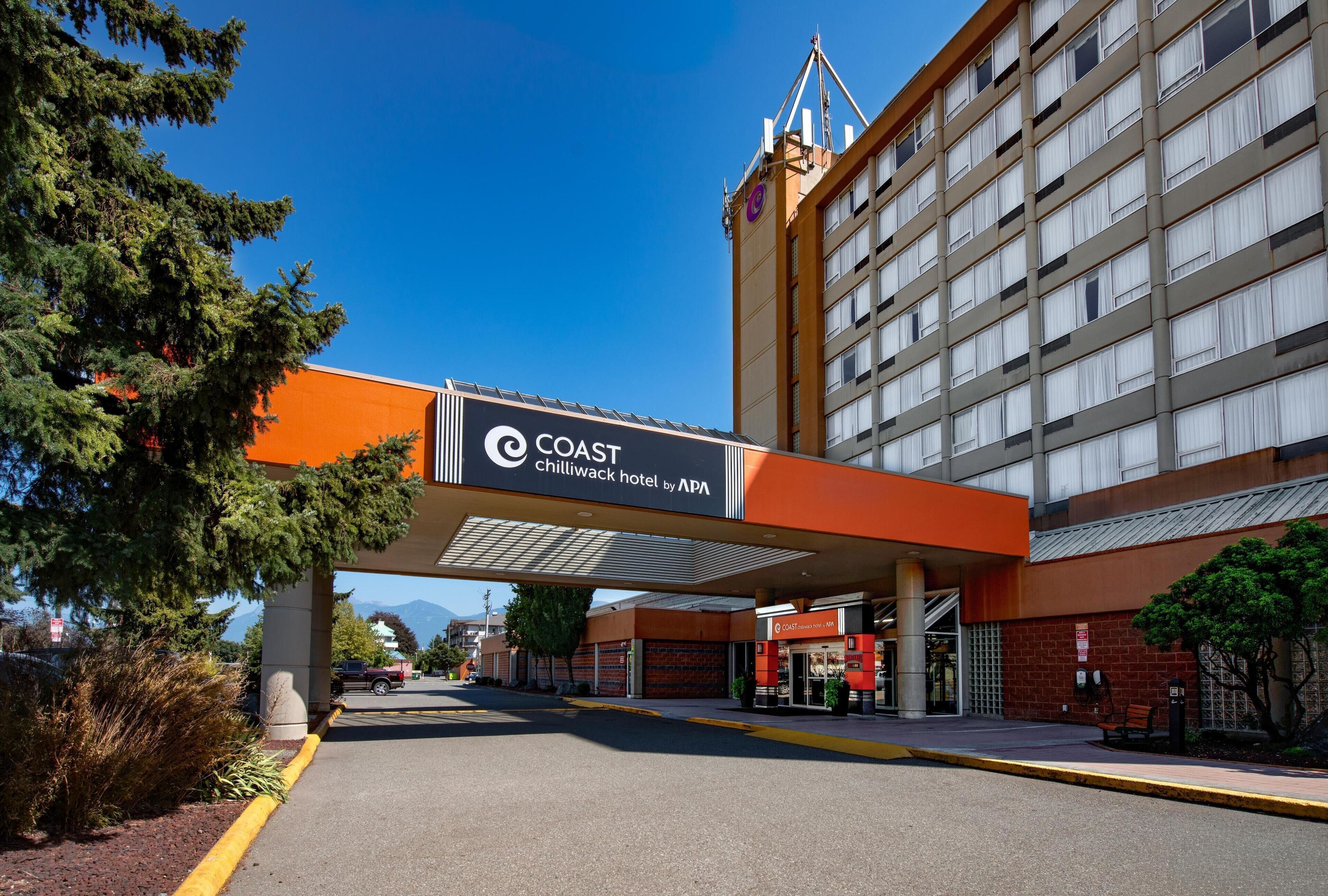 A hotel entrance with a sign for the Coast Chilliwack Hotel by APA.