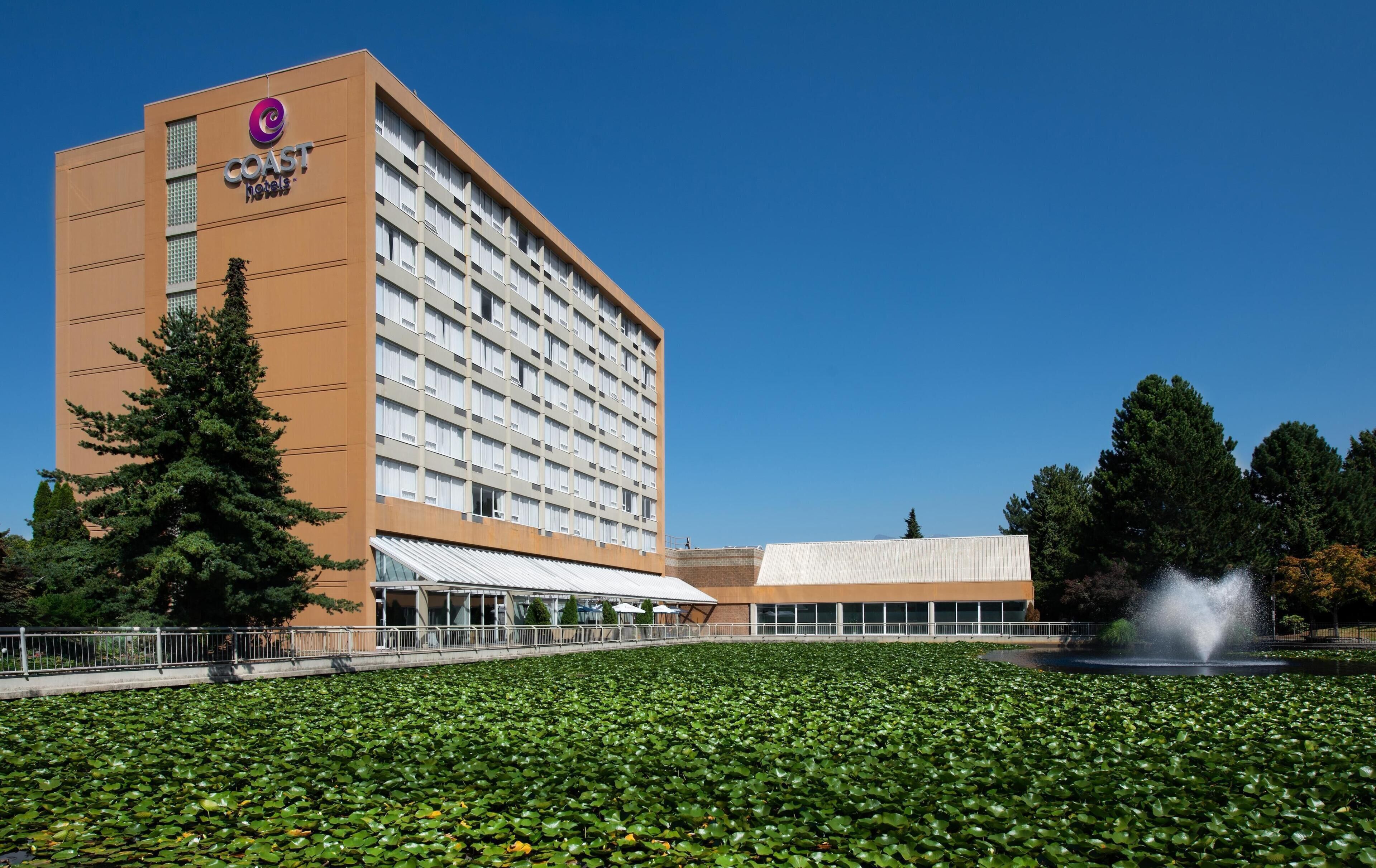A hotel with a modern design, featuring a large building with a prominent logo and a flat roof.