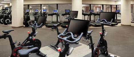 A gym with stationary bikes, treadmills, and exercise equipment.