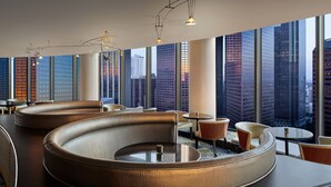 A modern lounge area with curved seating and large windows offering city views. - The Westin Bonaventure Hotel and Suites, Los Angeles (Los Angeles)