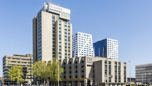 A hotel building with multiple floors, large windows, and a sign indicating it is a hotel.