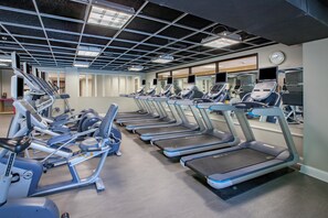 A gym with multiple treadmills, ellipticals, and exercise bikes. - Crowne Plaza Louisville Airport Expo Ctr by IHG (Louisville)