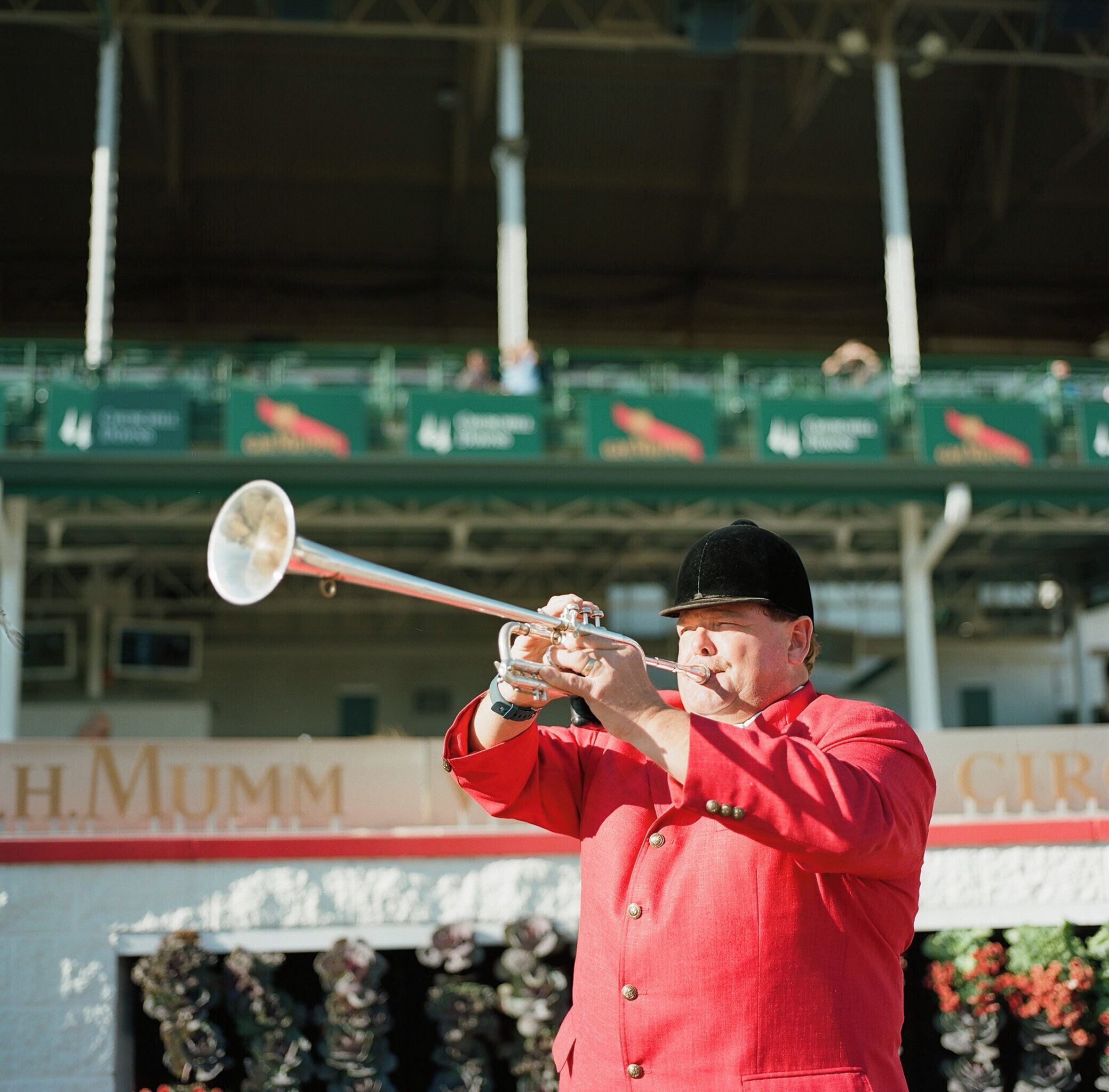 A person in a red uniform playing a trumpet.