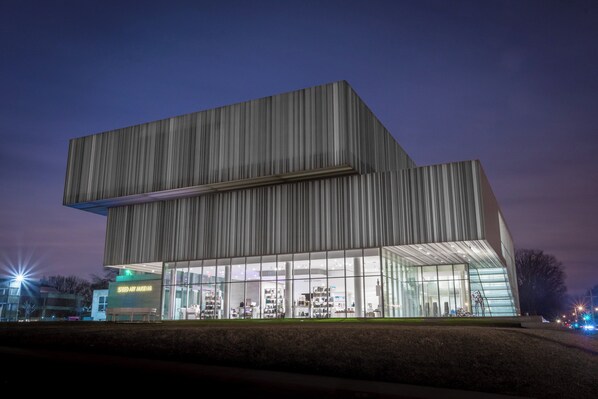 A modern building with a large glass facade and a flat roof.