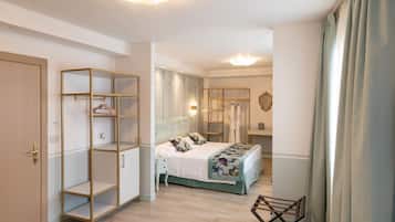 A bedroom with a bed, a wardrobe, a mirror, and a chair.
